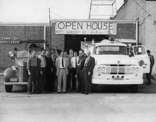 Montevallo Volunteer Fire Dept. Open House to celebrate delivery of new white Ford fire truck, 1960. (Left to Right) Milton Jeter, Harry Klotzman, Joe Myer, Mr. Drake (B'ham Civil Defense), Clay Nordan (on back of truck), Bill Pendleton (Chief), Dudley Pendleton, Harvey Rochester, Mike Mahan, Cooper Shaw, Clarence Chism. Photograph by Pat Wyatt.